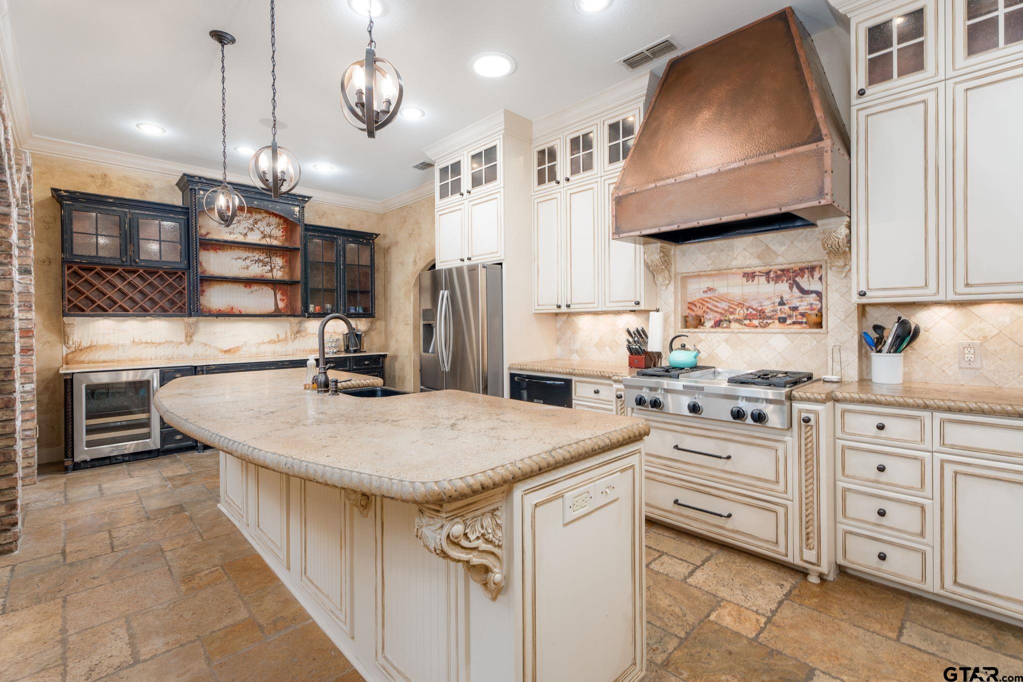 a kitchen with stainless steel appliances granite countertop a sink a stove and a refrigerator