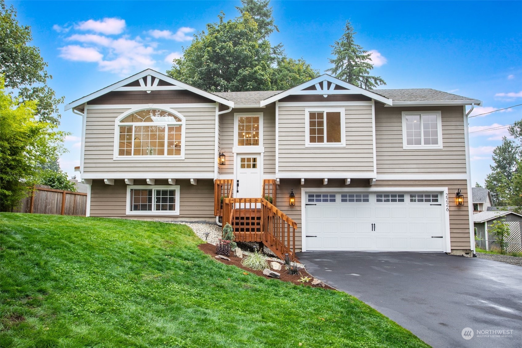 a front view of a house with a yard and garage