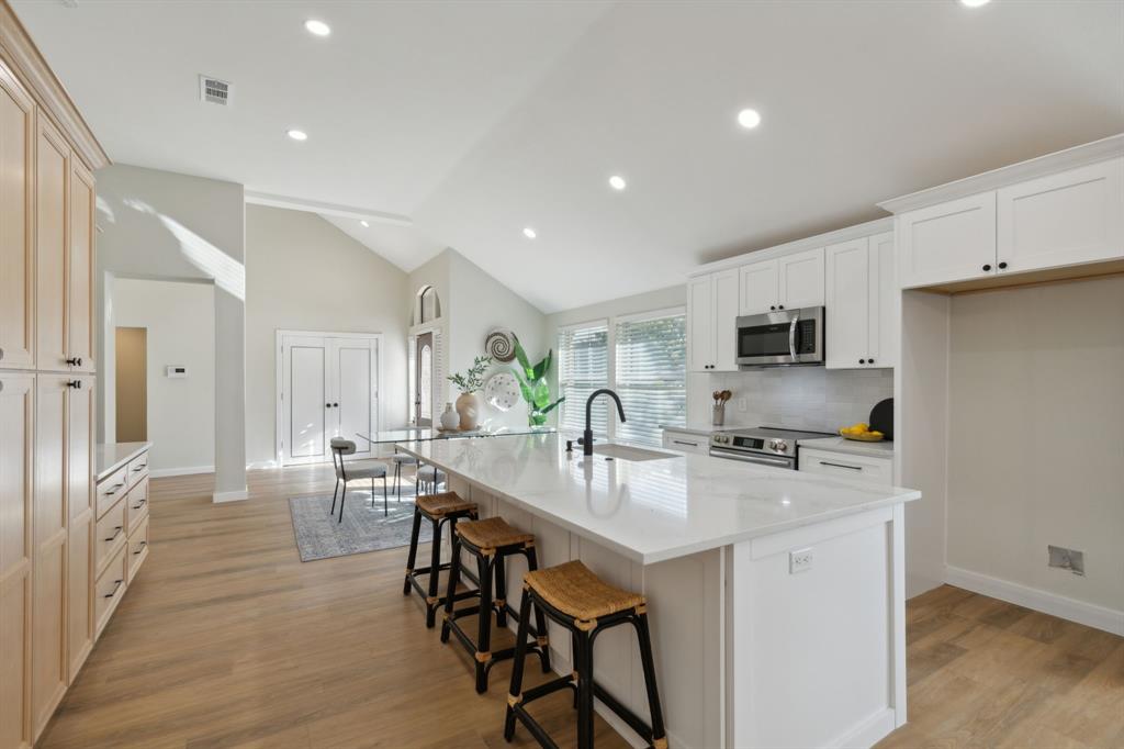 a kitchen with stainless steel appliances granite countertop counter space dining table and chairs