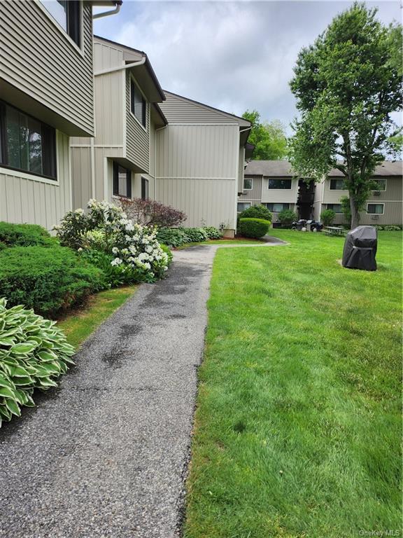 a view of a house with backyard and a garden