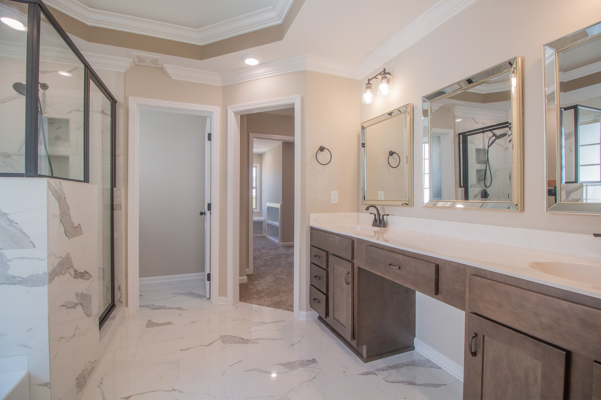 a spacious bathroom with a shower sink and mirror