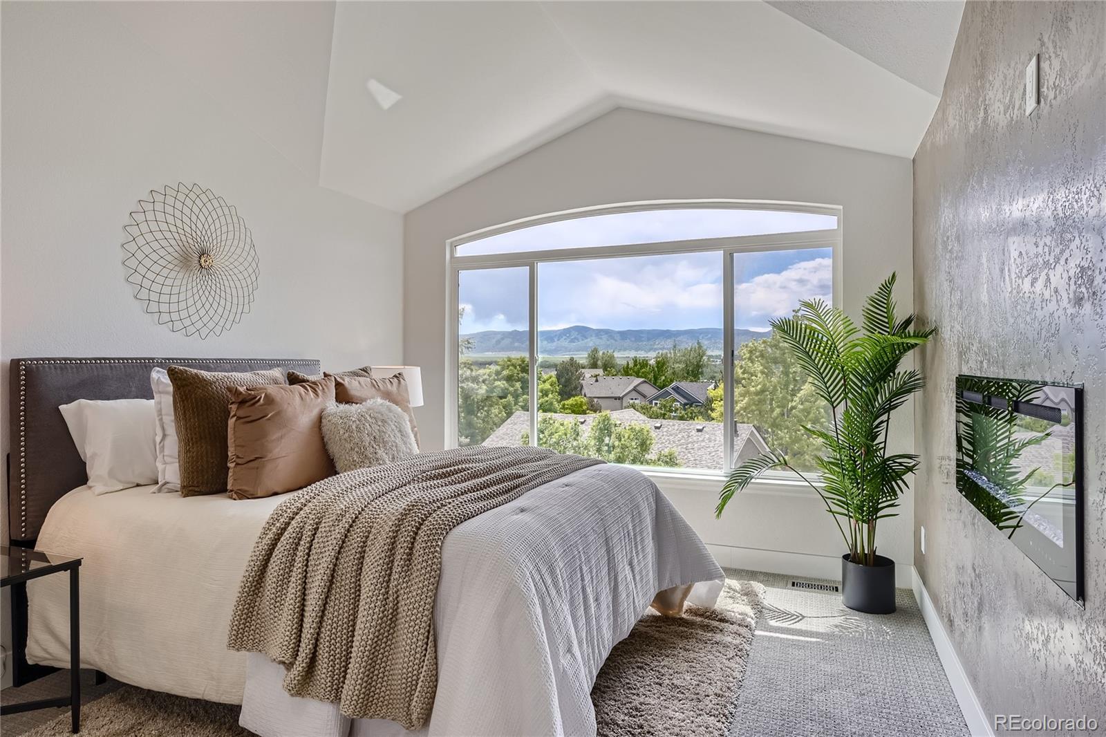 a bed sitting in a bedroom next to a window