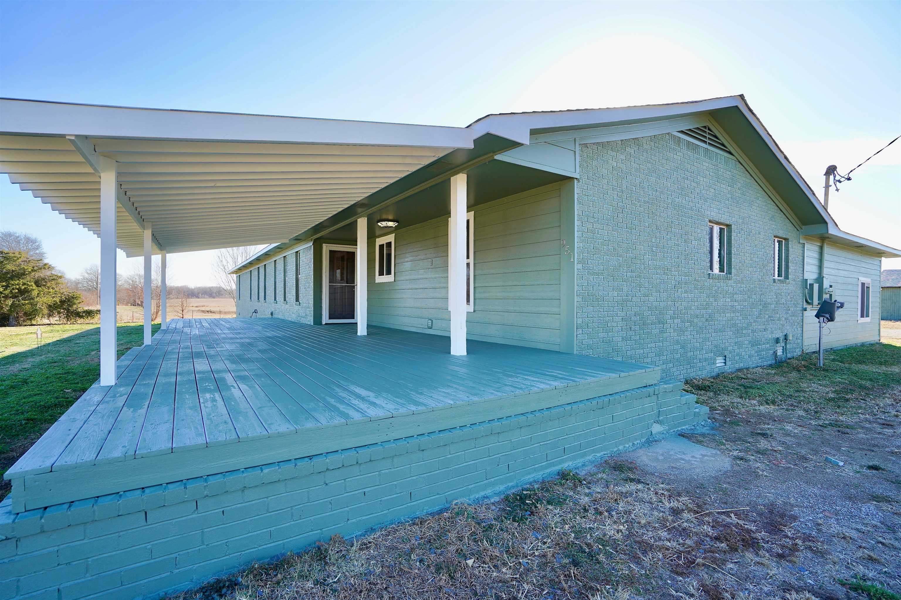 a view of backyard of house with wooden floor