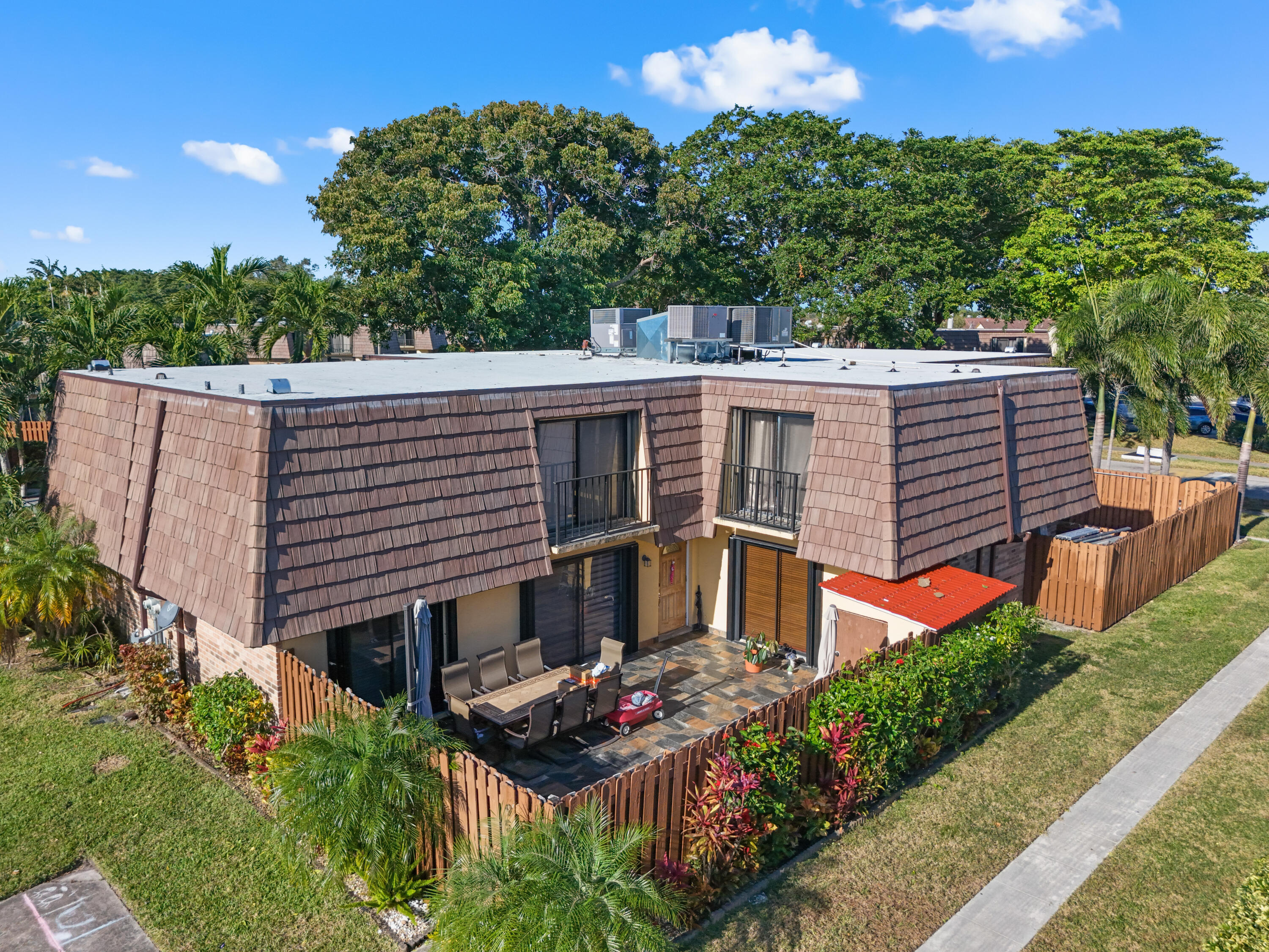 aerial view of a house with a yard and potted plants