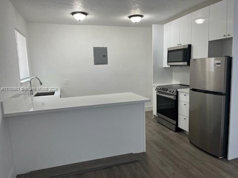 a kitchen with granite countertop a refrigerator stove and sink