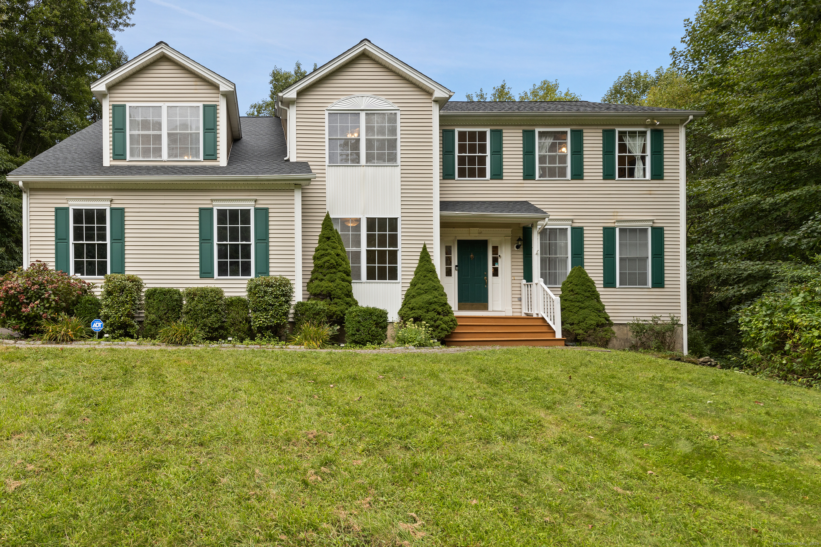 a front view of a house with a yard