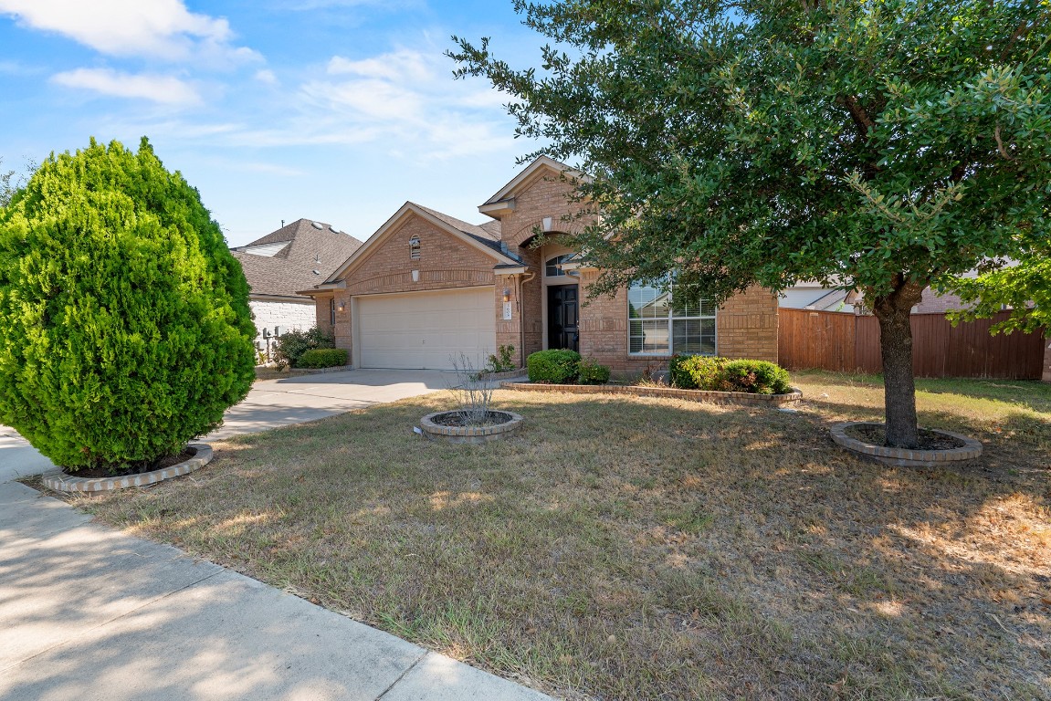 a front view of a house with a yard and a garage