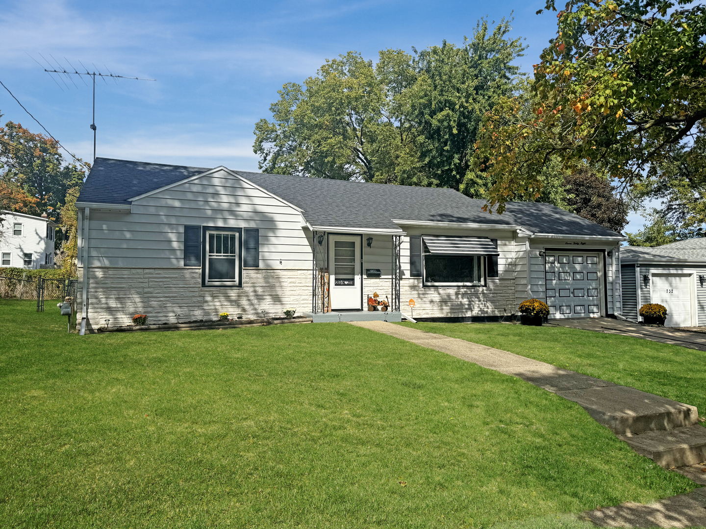 a front view of a house with a garden