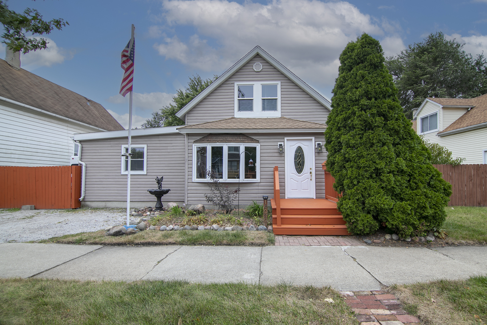 a front view of a house with a garden