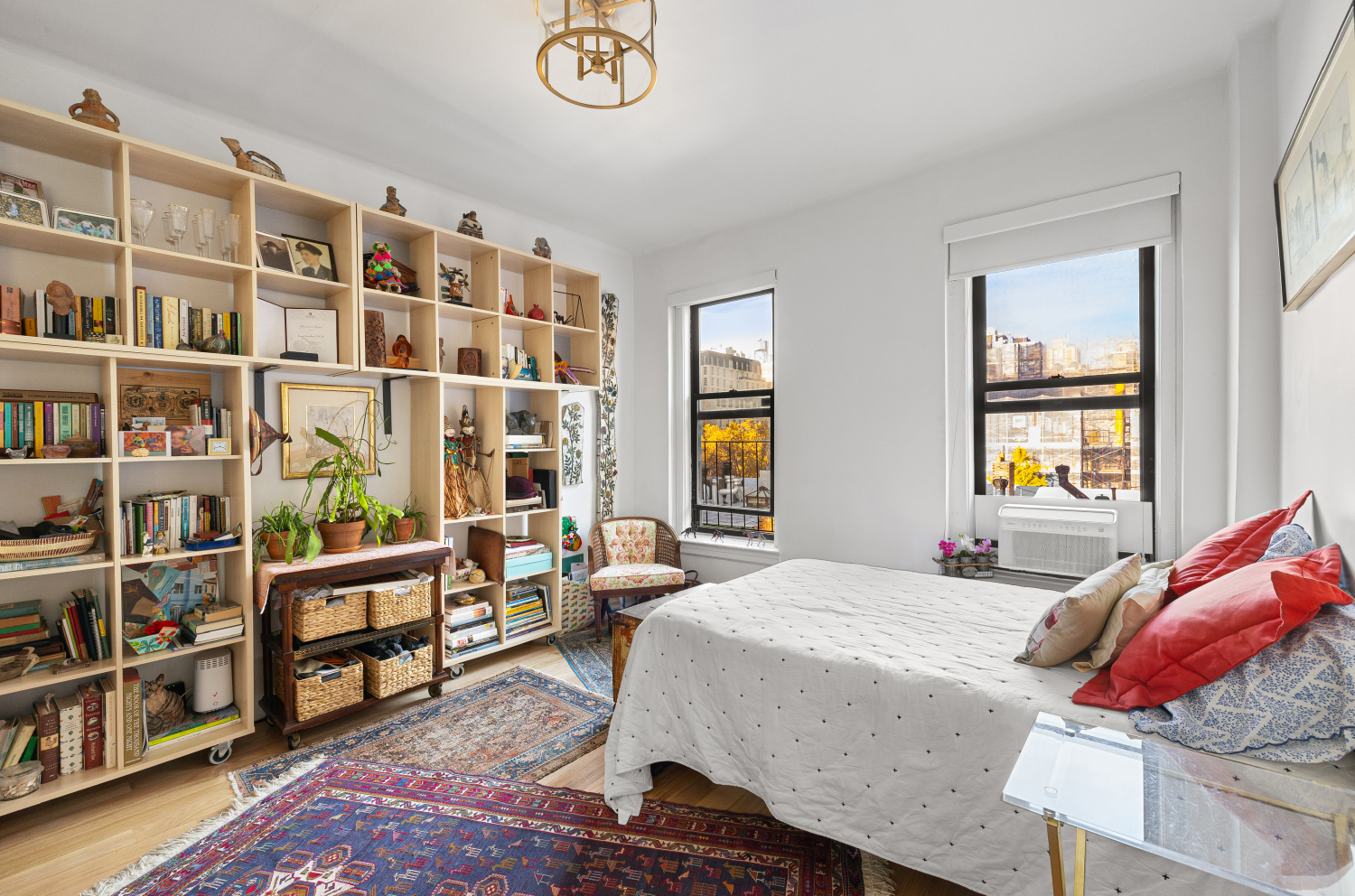 a bedroom with a bed cabinets and window