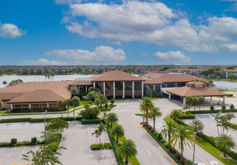 an aerial view of a house with swimming pool garden and lake view