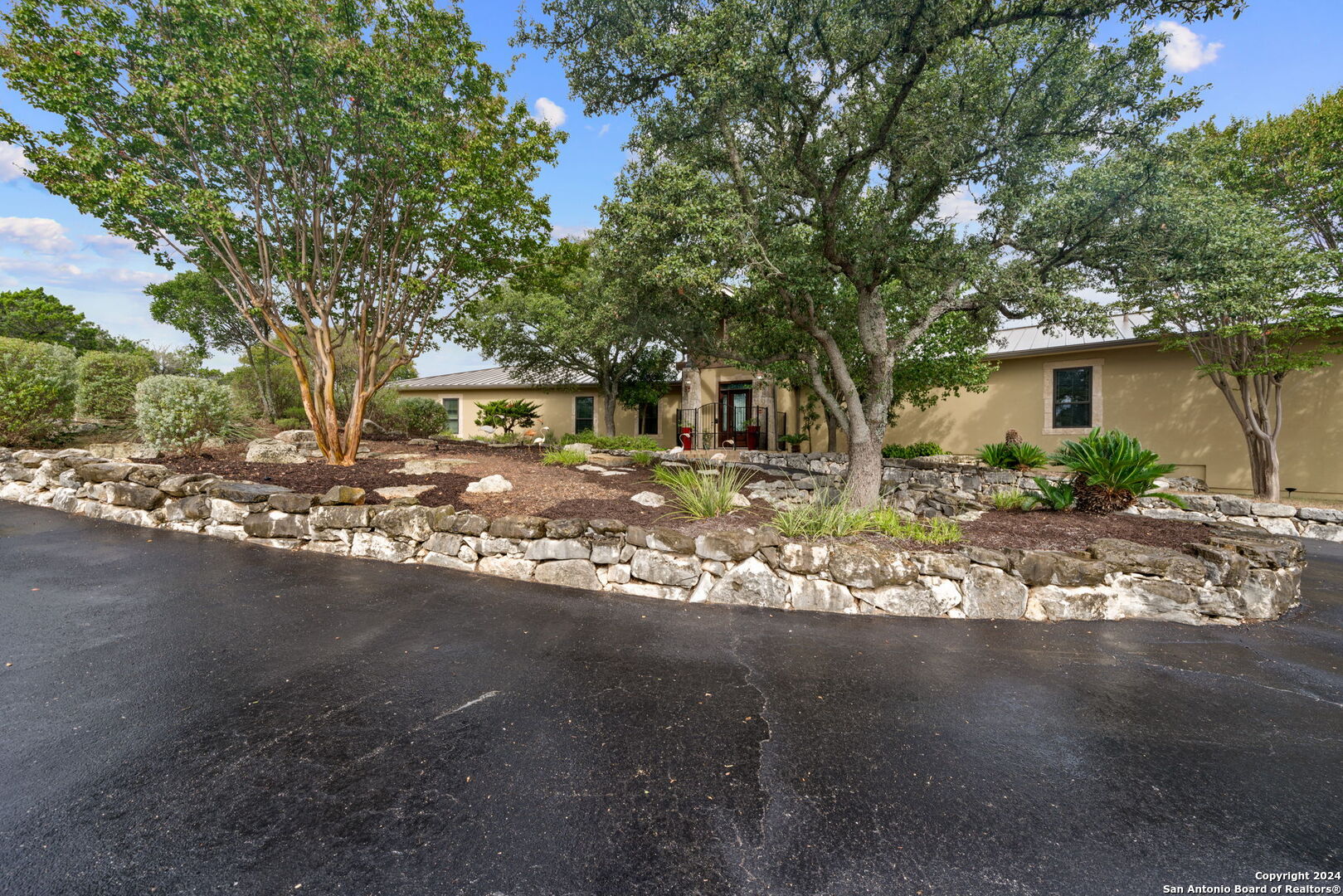 a front view of a house with garden