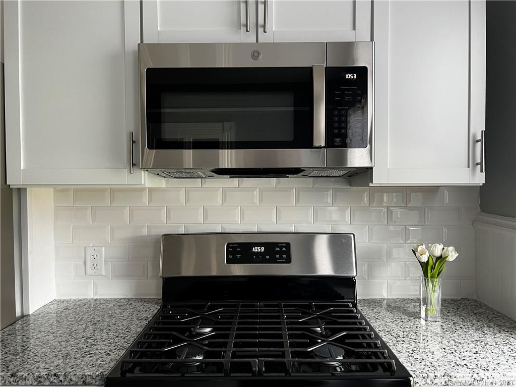 a kitchen with a stove and microwave