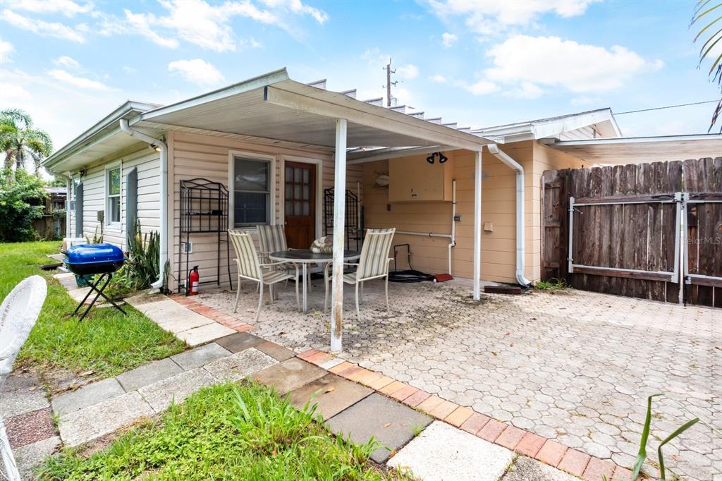 a view of house with patio outdoor seating and covered with yard