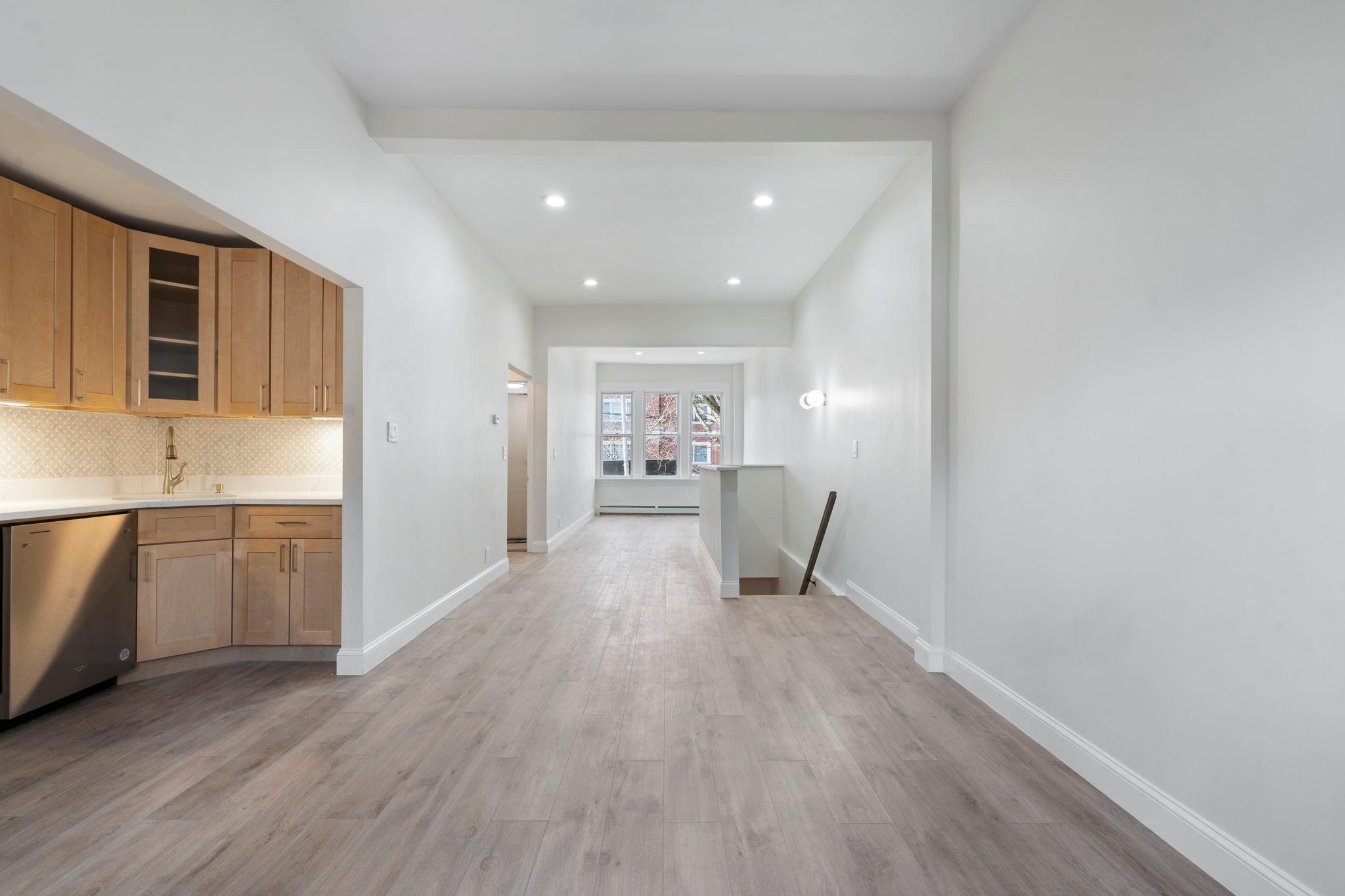 a view of kitchen with wooden floor and electronic appliances