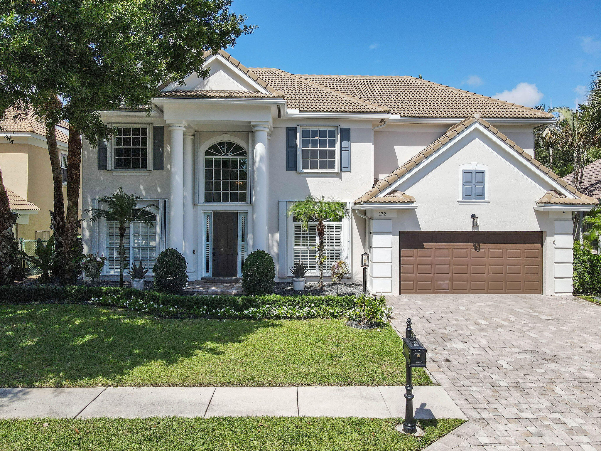 a front view of a house with a yard and garage