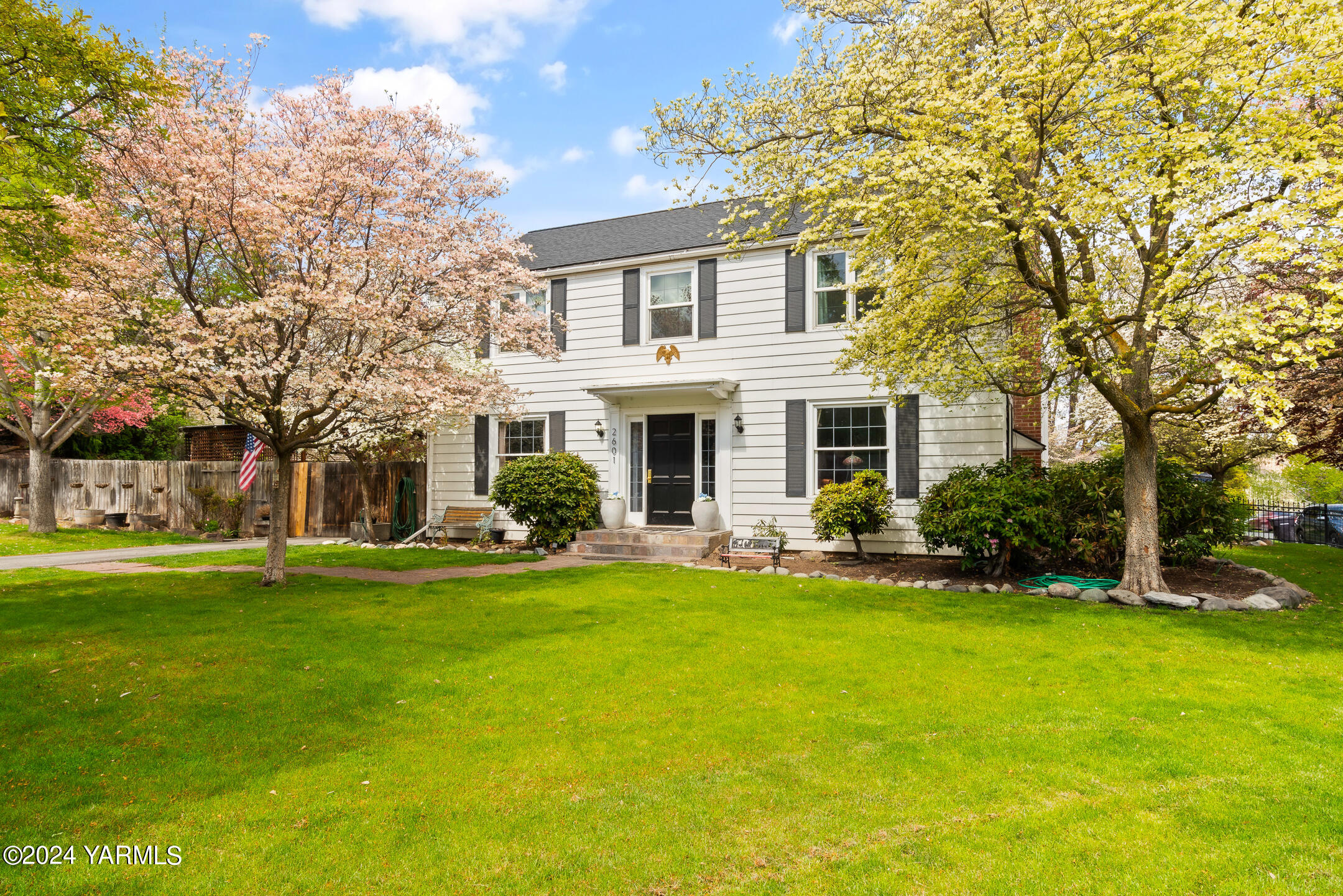 a front view of house with yard and green space