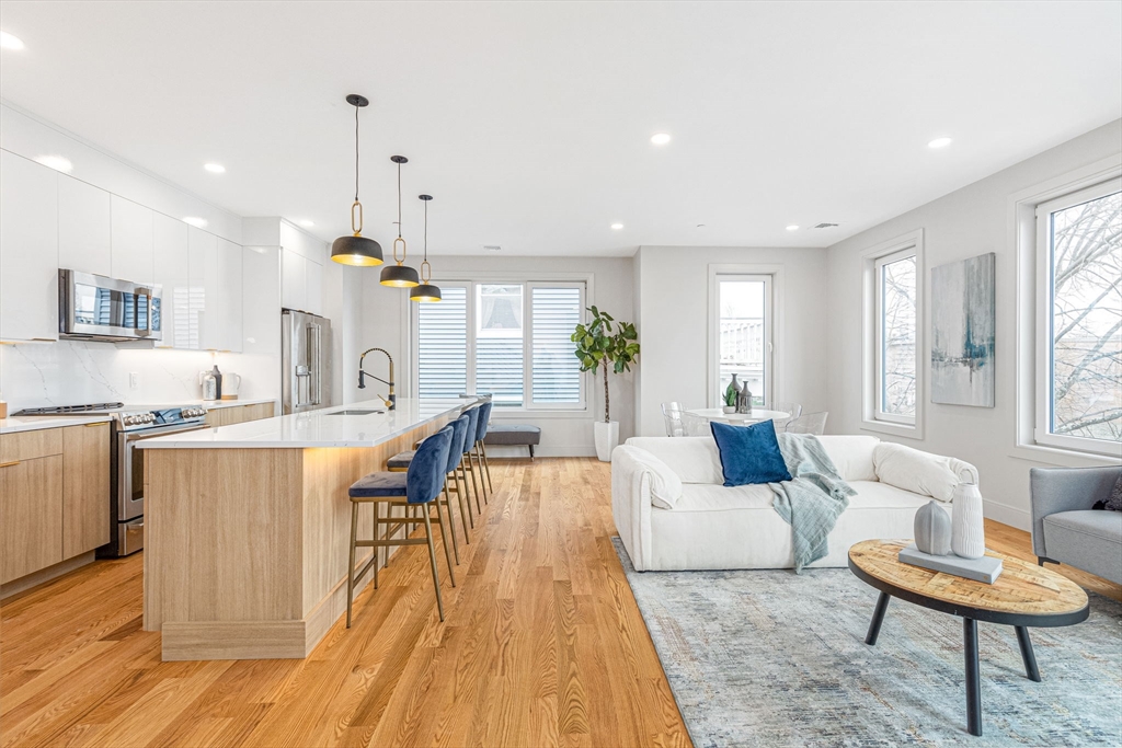 a living room with kitchen island furniture and a wooden floor