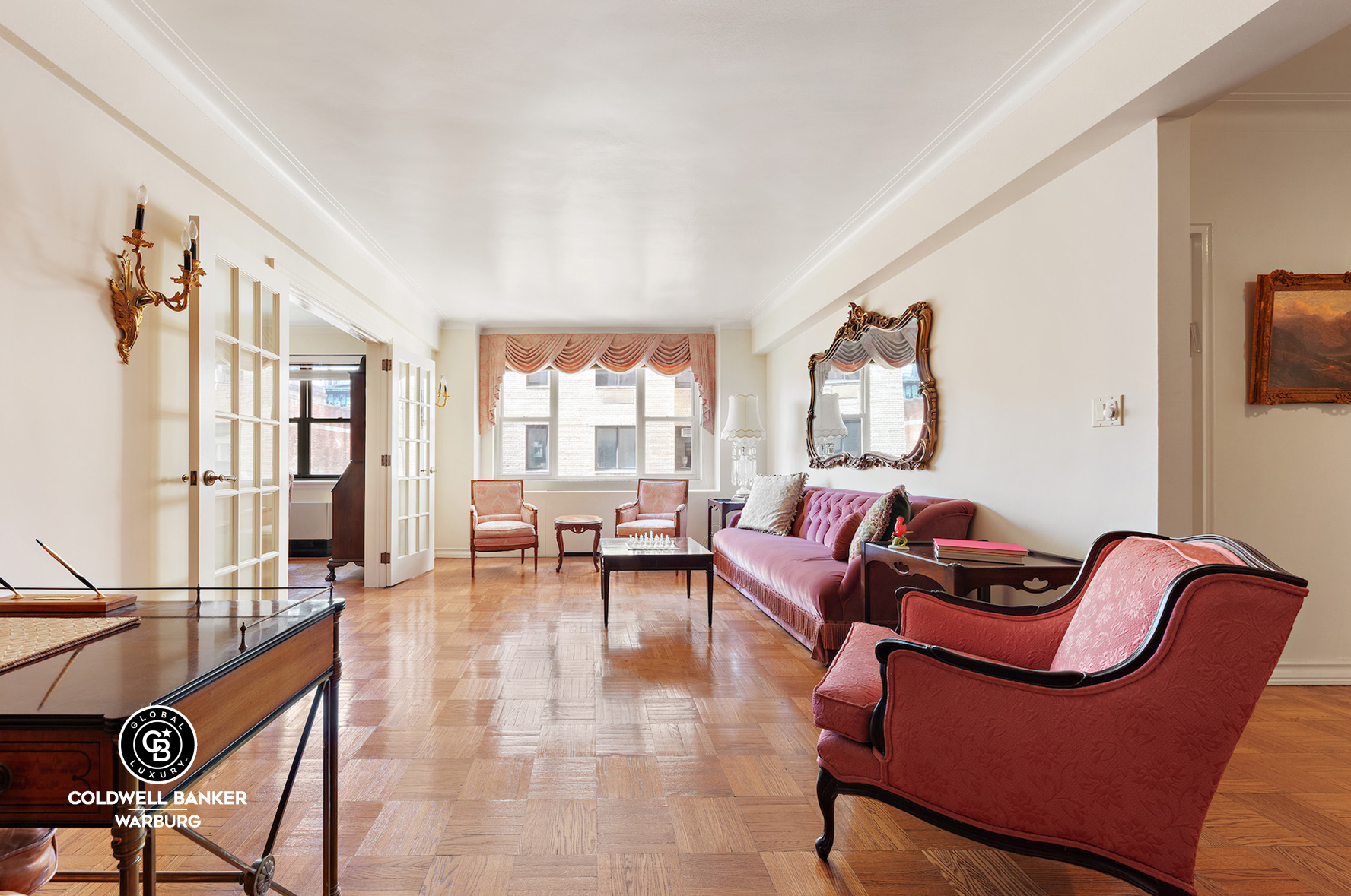 a living room with furniture and a floor to ceiling window