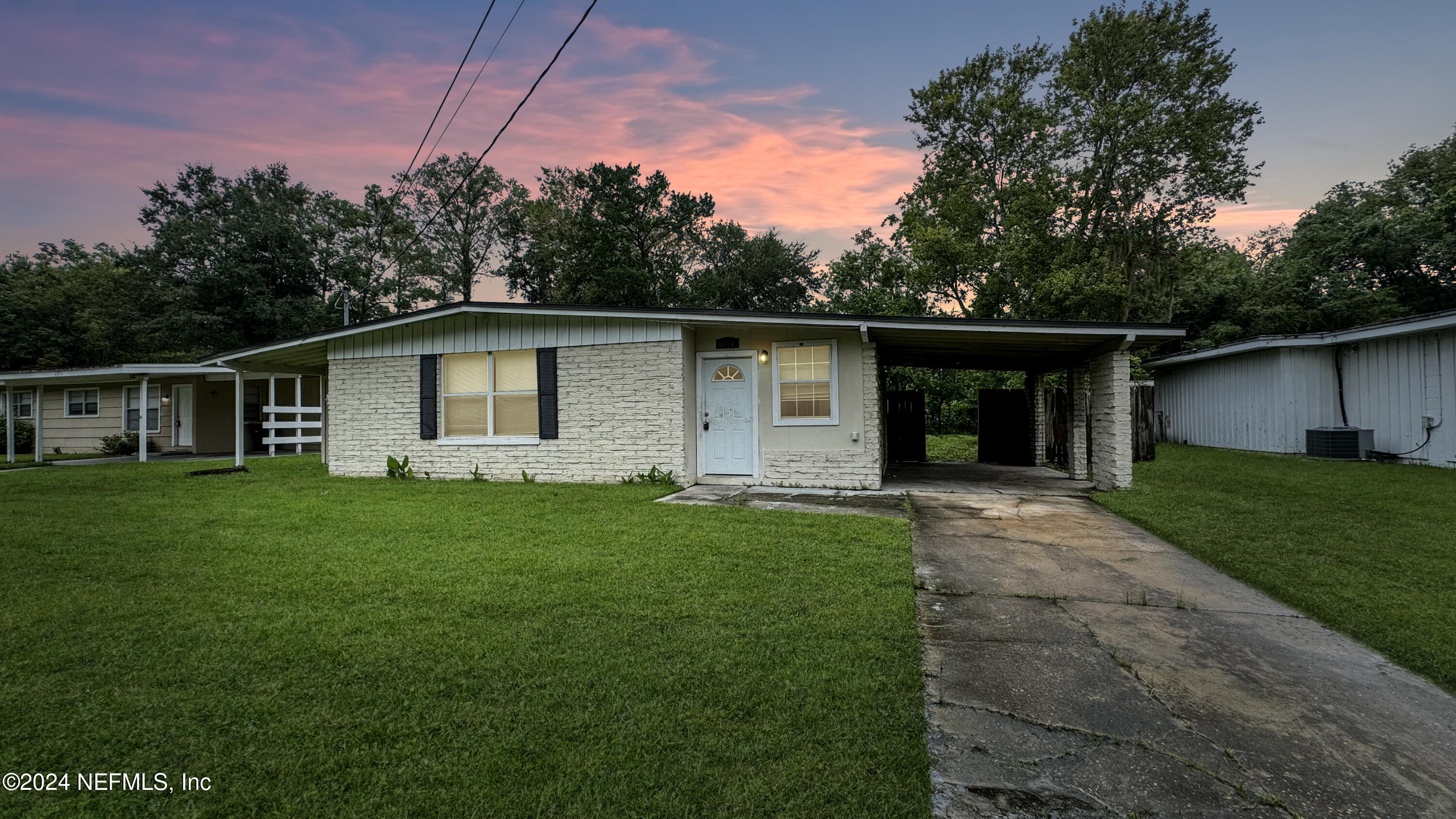 a front view of house with yard and green space