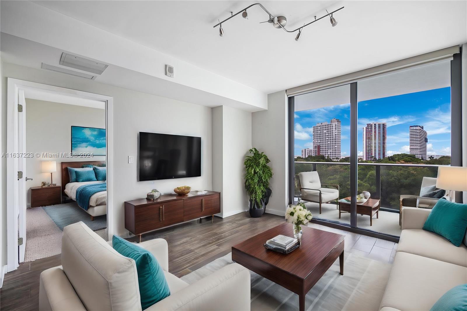 a living room with furniture a rug and a flat screen tv