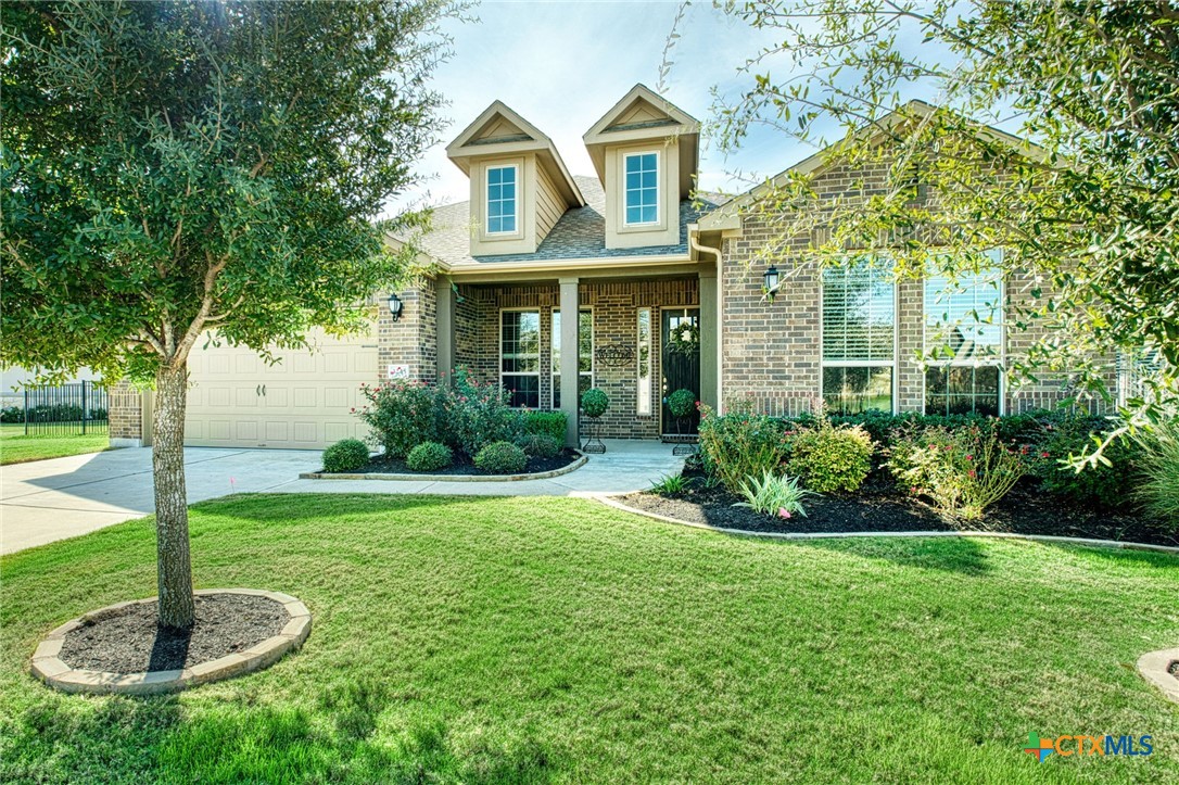 a front view of a house with garden