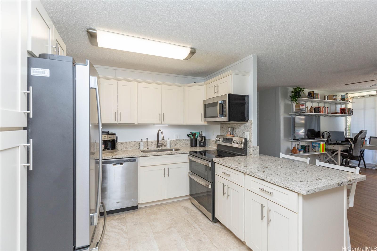 a kitchen with a sink stove and microwave