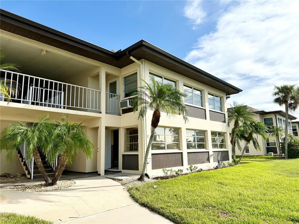 a view of a house with backyard porch and sitting area