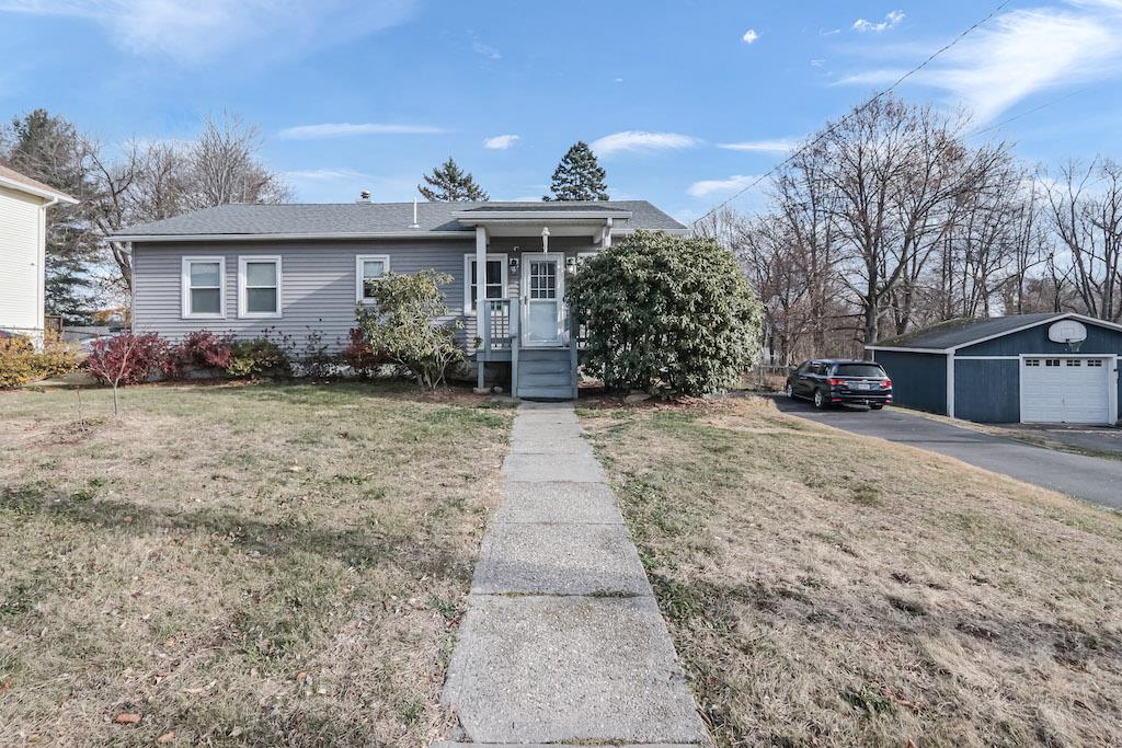 a view of a house with a yard and garage