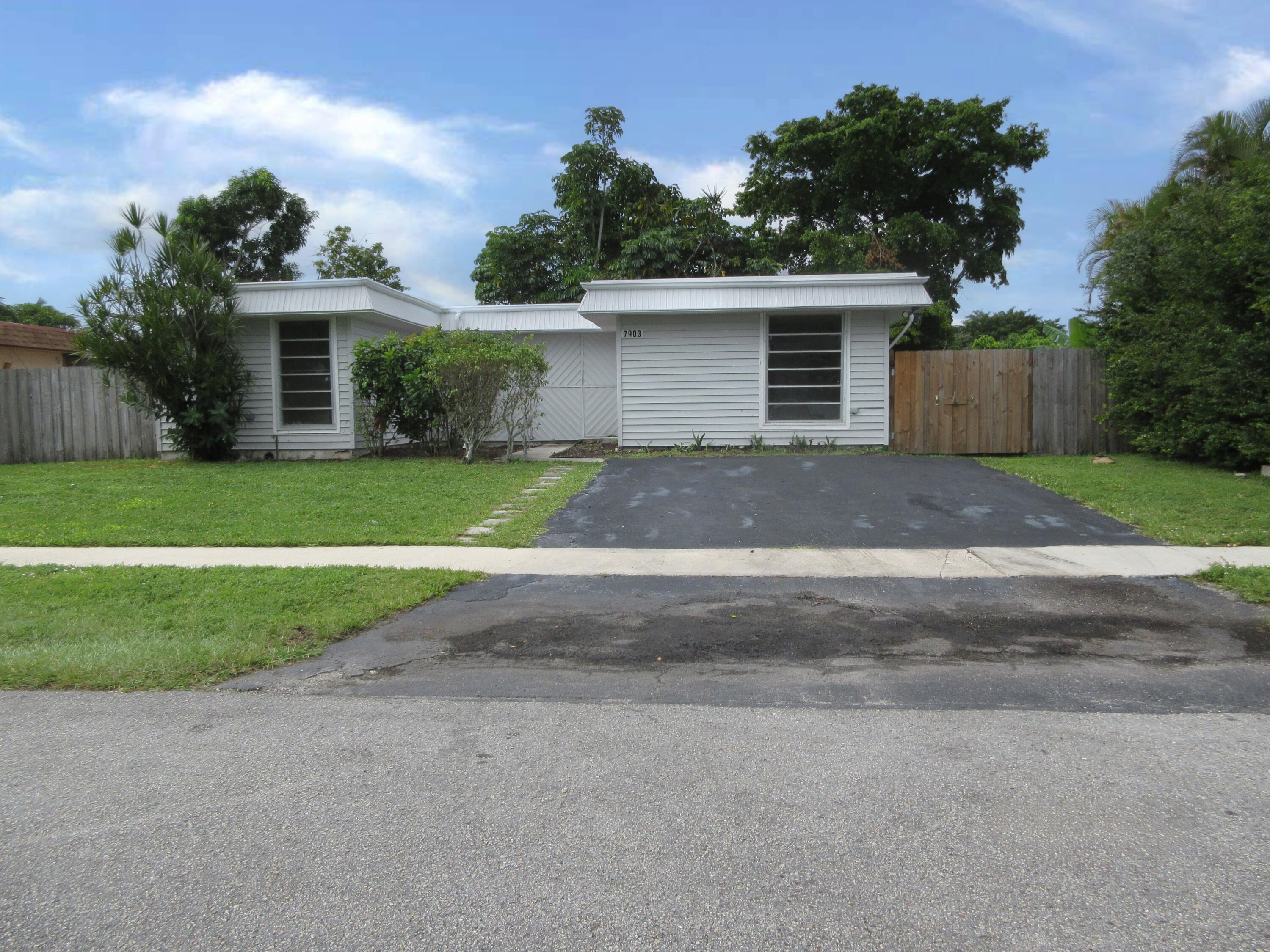 front view of a house with a yard and a garage