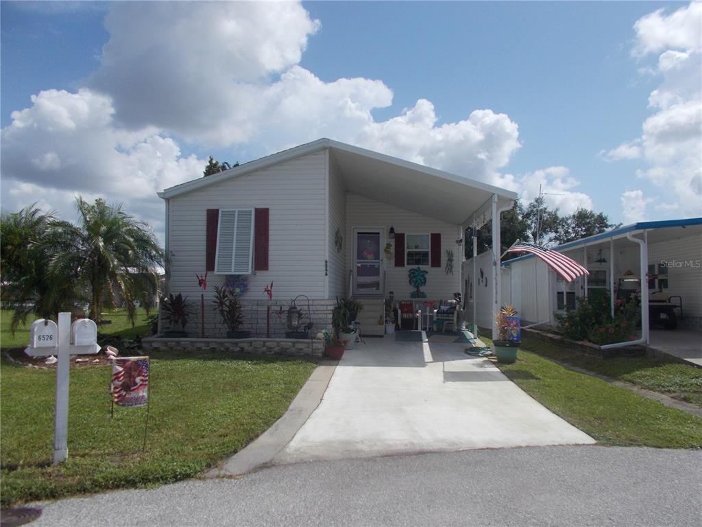 a front view of house with yard and outdoor seating