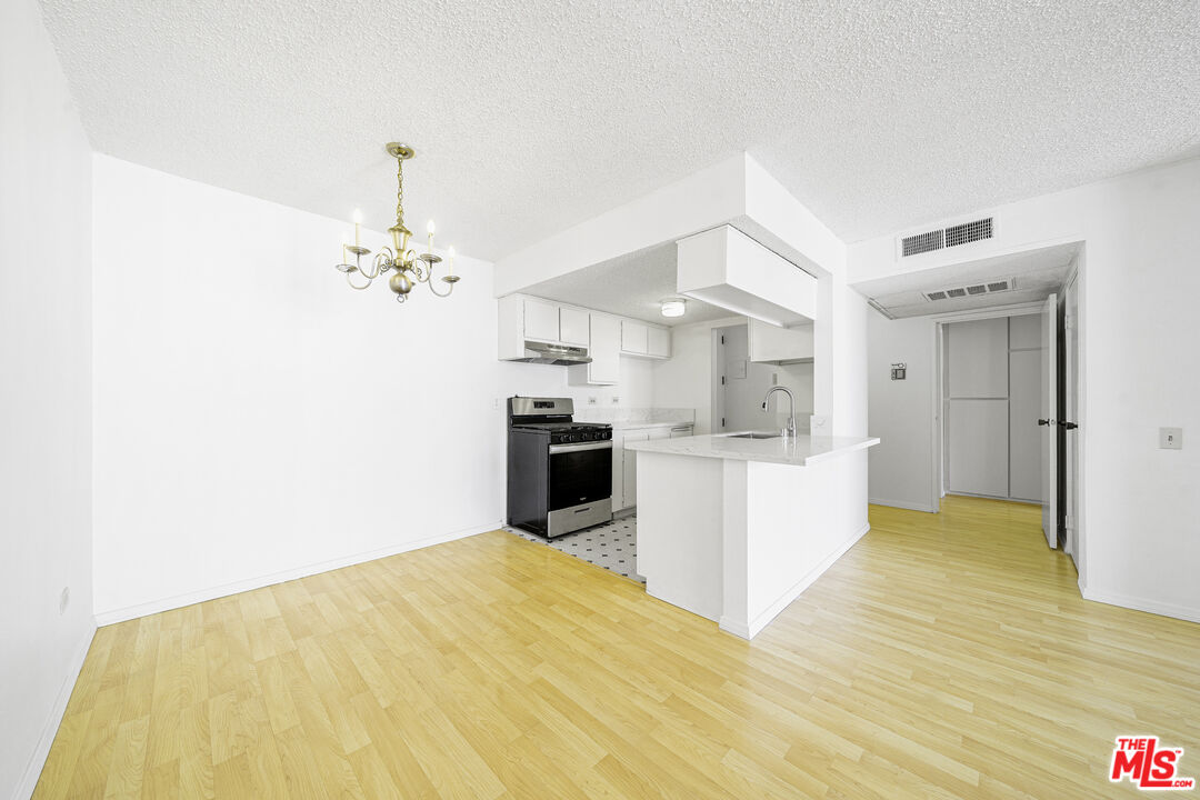 a view of kitchen with cabinets and wooden floor