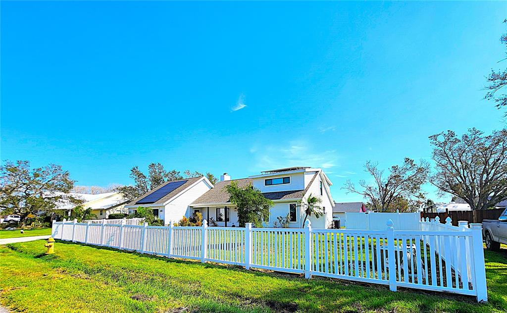 a view of a house with a backyard