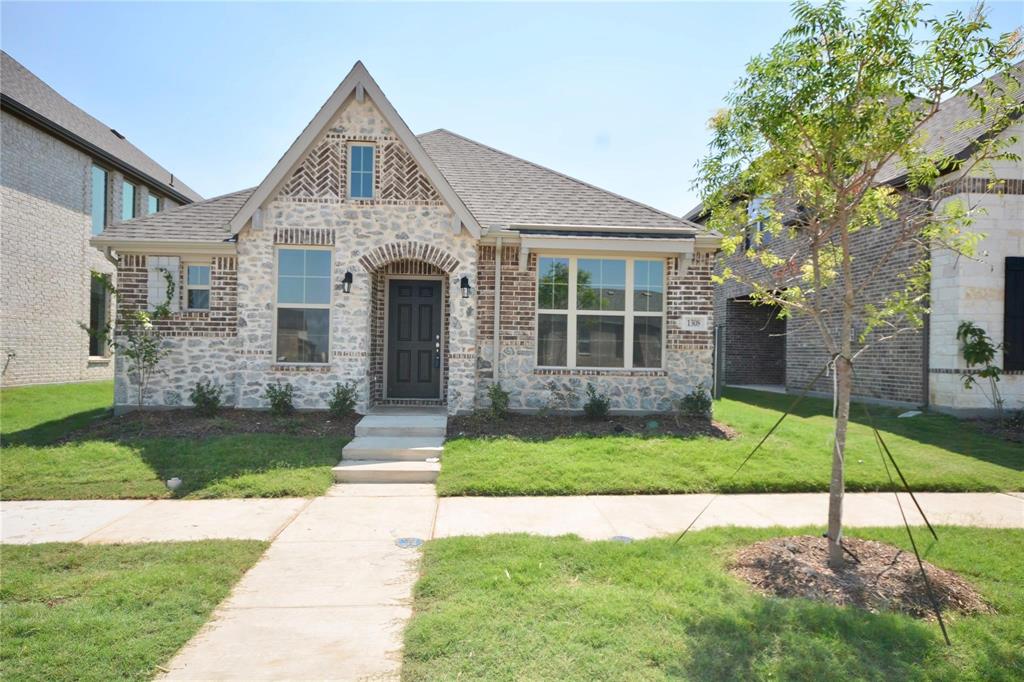 a front view of a house with a yard and porch