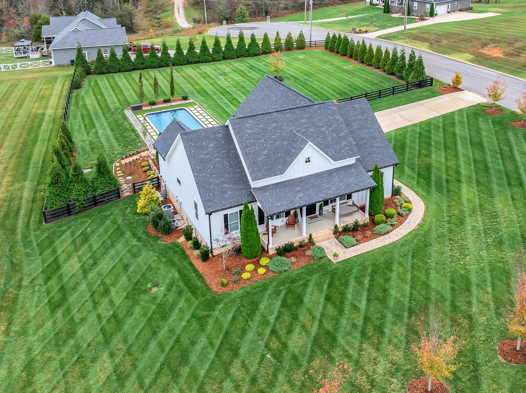 an aerial view of a house with swimming pool garden and patio