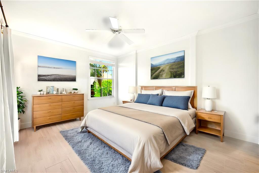 a bedroom with a large bed and a flat tv screen on dresser