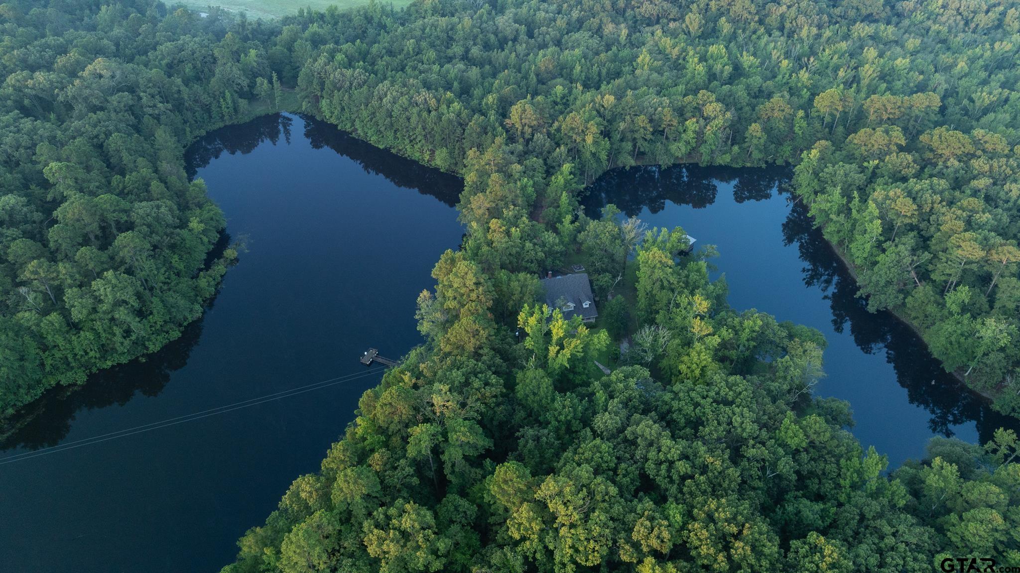 an aerial view of a house with pool outdoor seating and yard