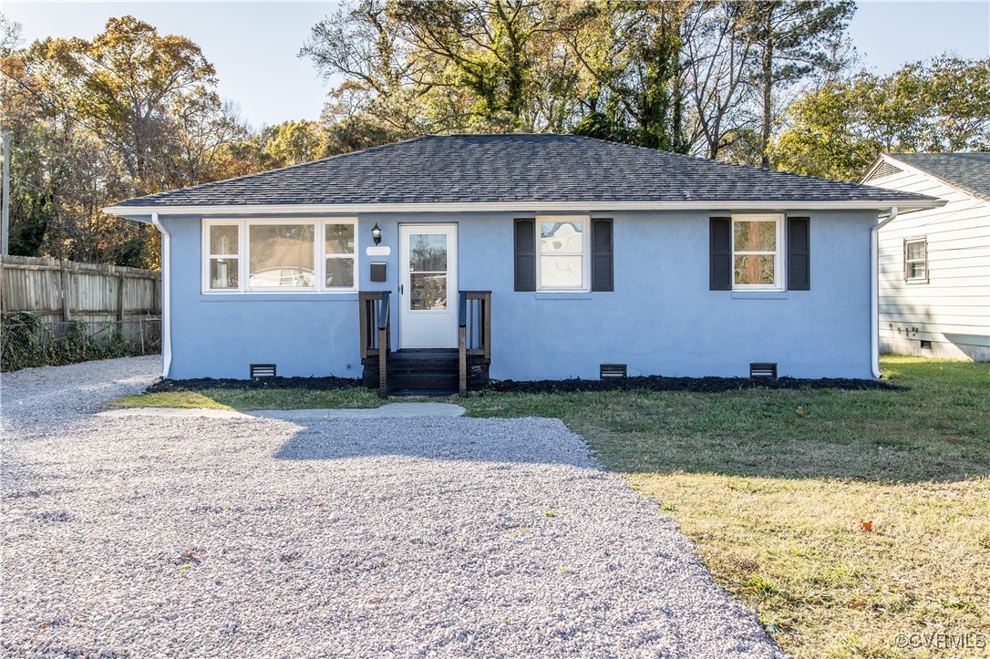 a front view of house with yard and trees