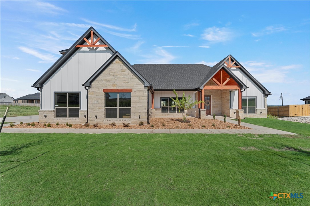 a front view of house with backyard and green space