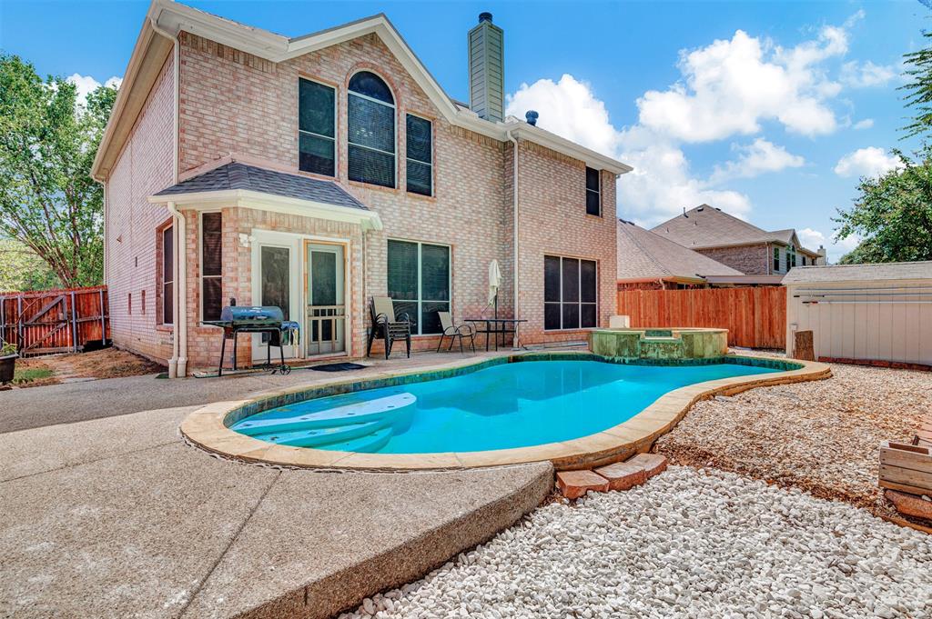 a front view of a house with swimming pool having outdoor seating