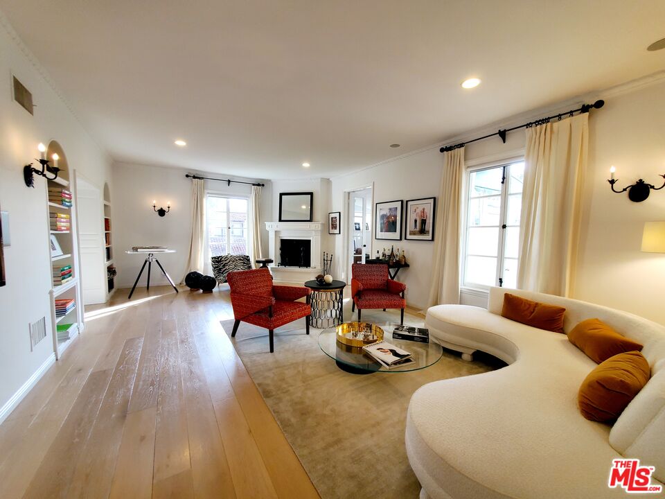 a living room with furniture window and wooden floor