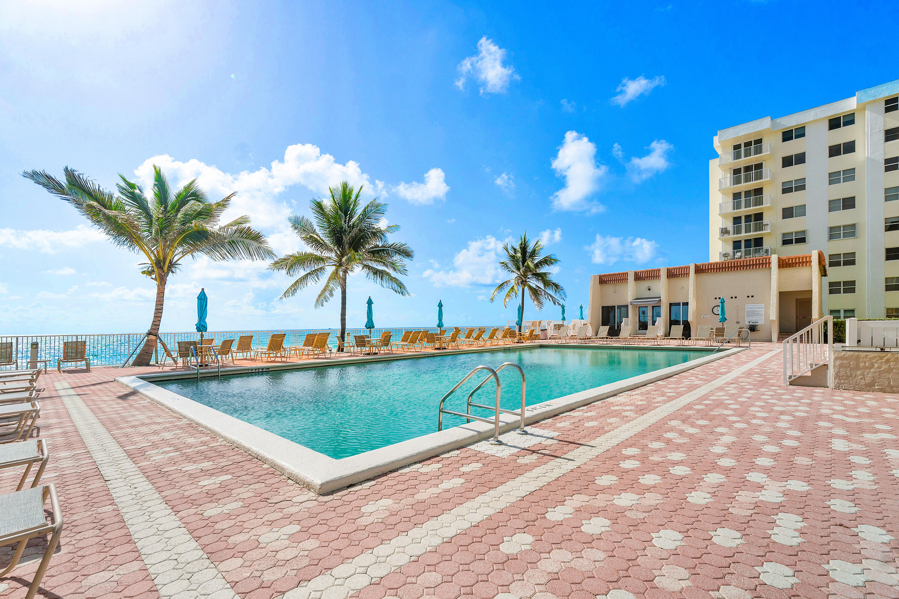 a view of a swimming pool with a lounge chair