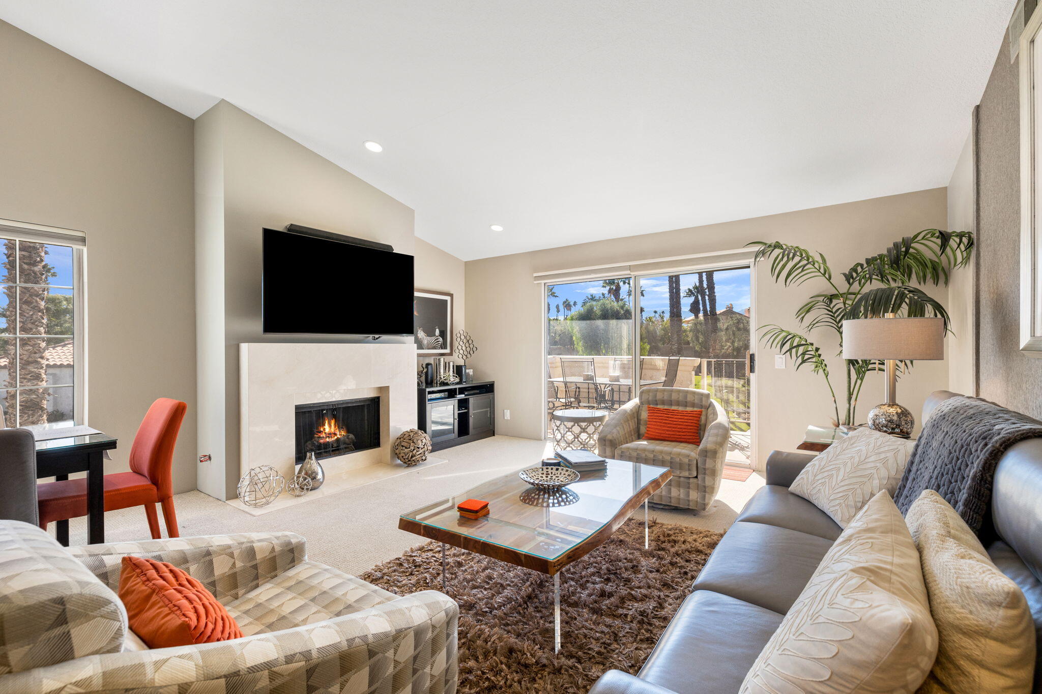 a living room with furniture a fireplace and a flat screen tv