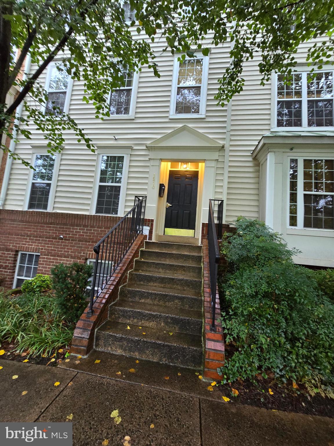 a view of a house with more windows and brick walls