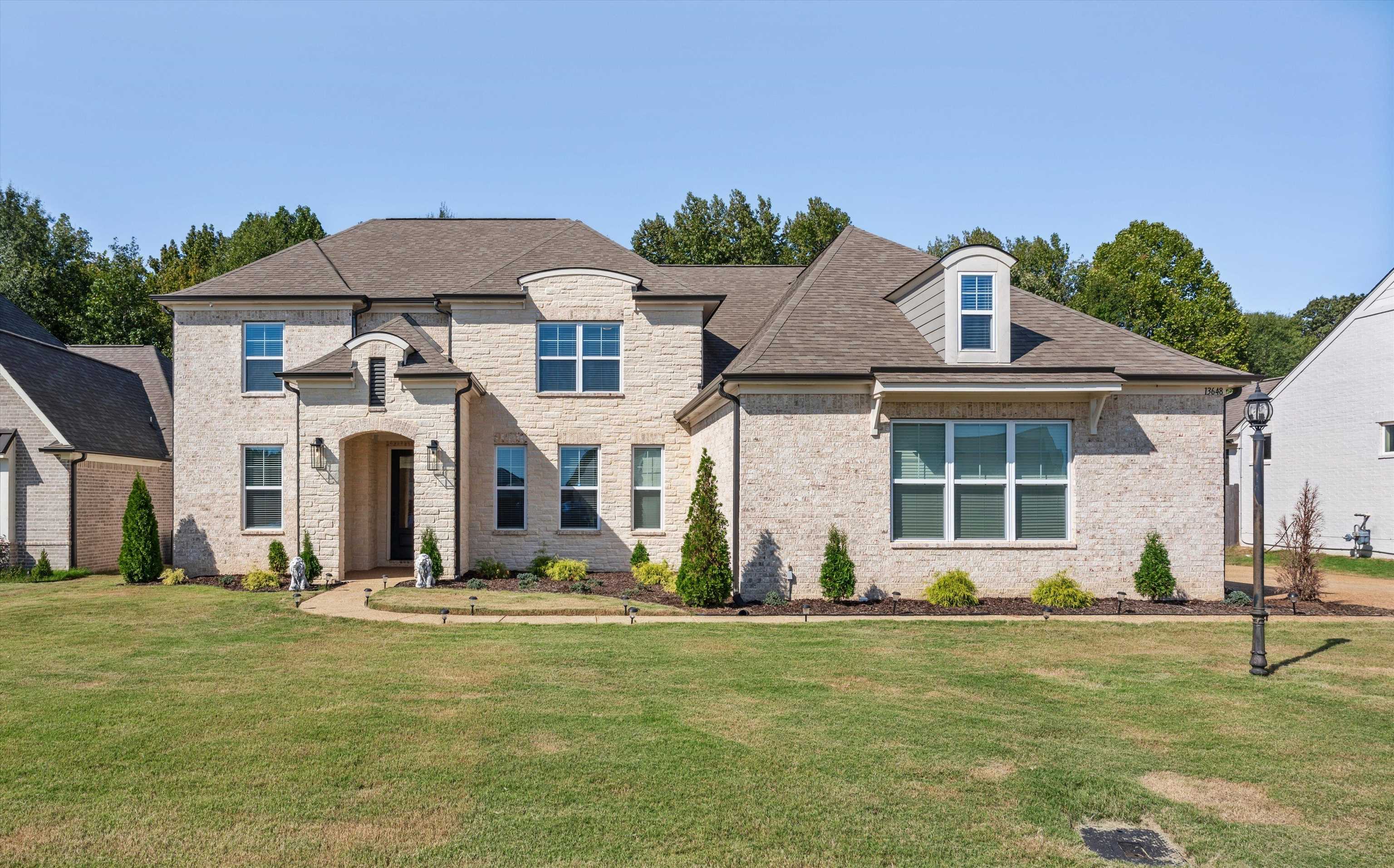 French country home featuring a front lawn