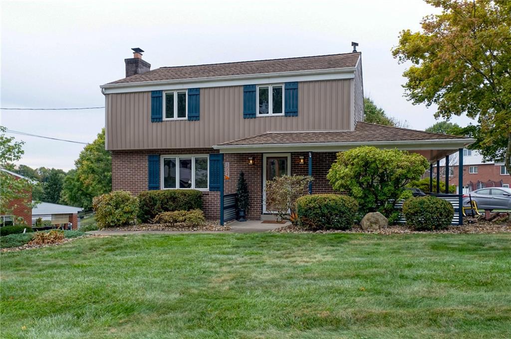 a front view of a house with garden and porch