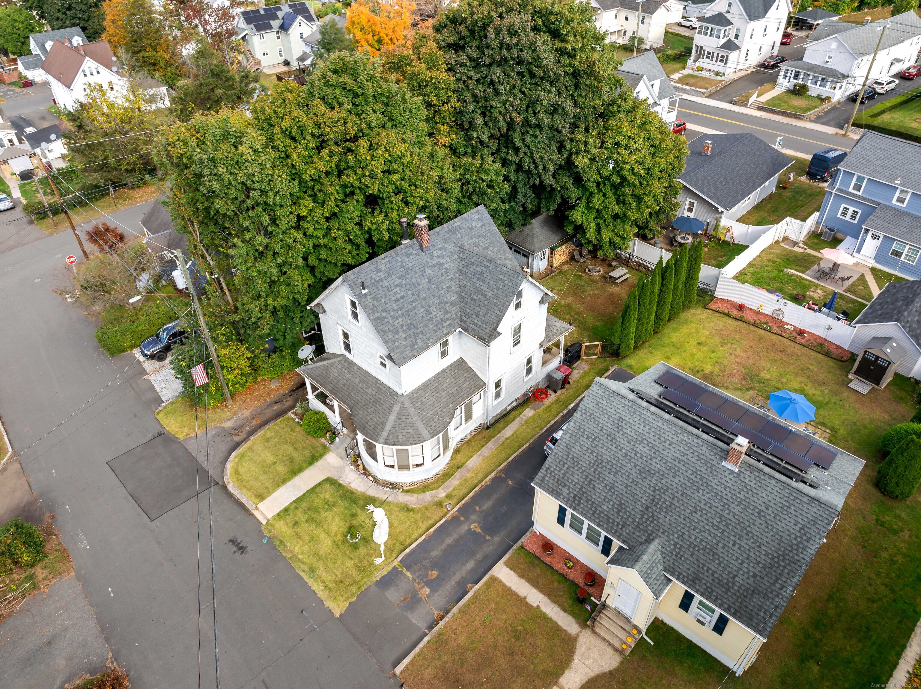 an aerial view of a house with swimming pool and outdoor seating