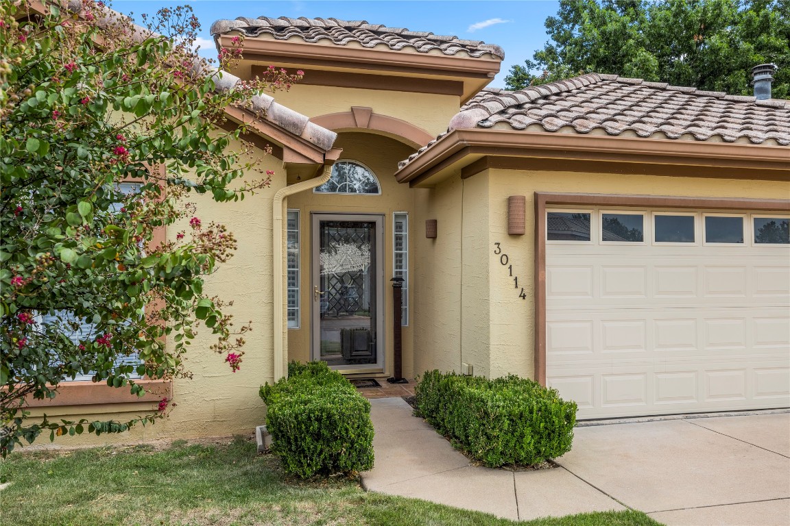 a front view of a house with plants