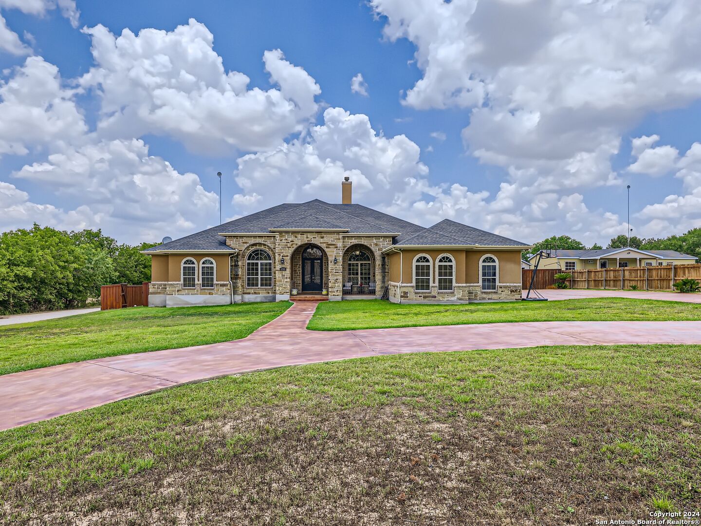 a front view of a house with a big yard