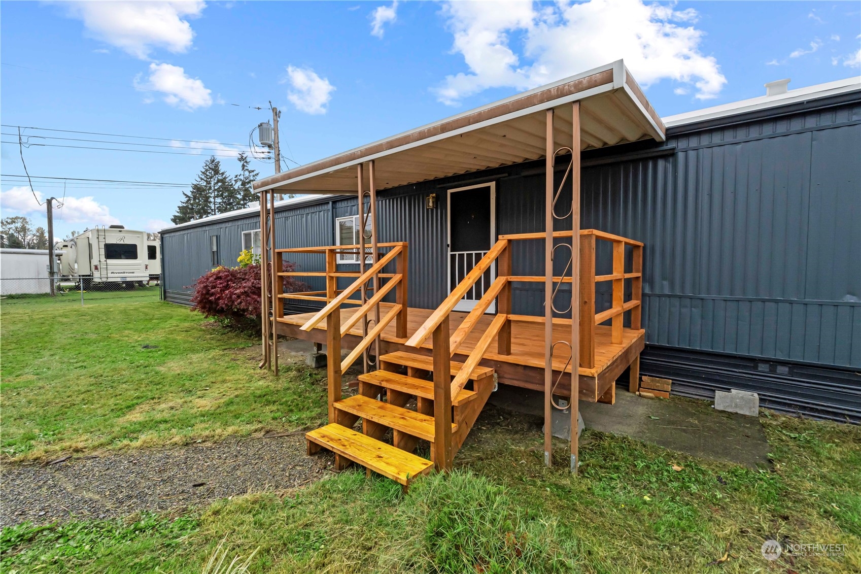 a backyard of a house with table and chairs